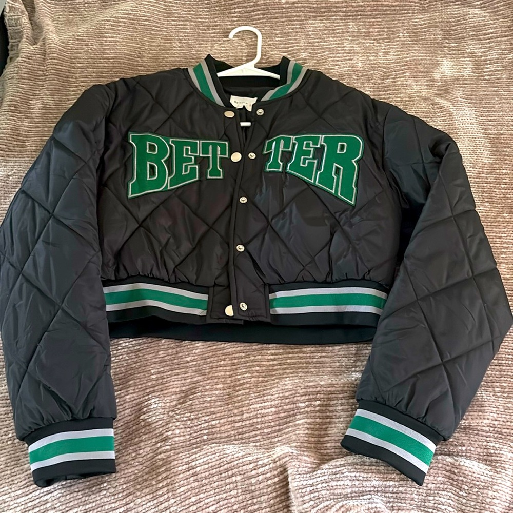 bomber jacket emblazoned with “BETTER” across the front